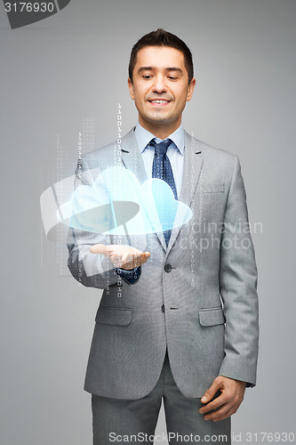 Image of happy businessman showing virtual cloud projection