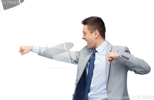 Image of businessman in suit fighting with someone
