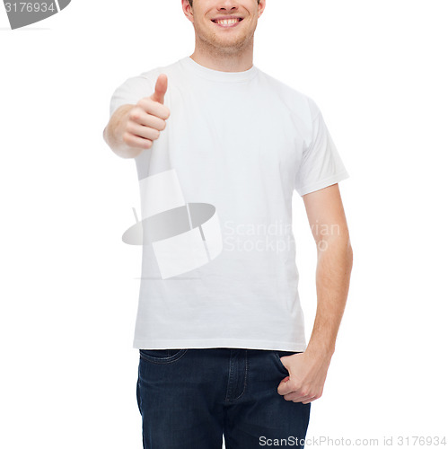 Image of smiling man in white t-shirt showing thumbs up