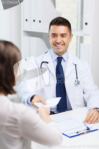 Image of smiling doctor and young woman meeting at hospital