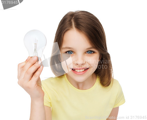 Image of smiling little girl holding light bulb