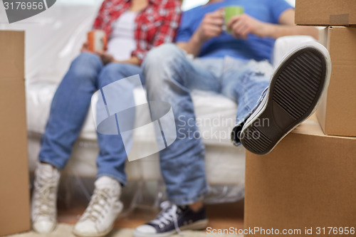 Image of close up of couple relaxing on sofa in new home