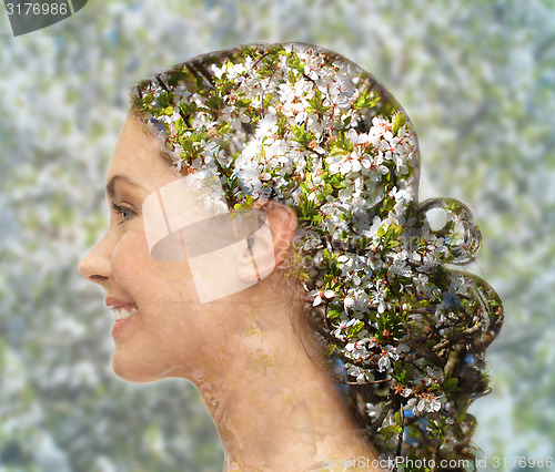 Image of happy woman face over blooming tree pattern