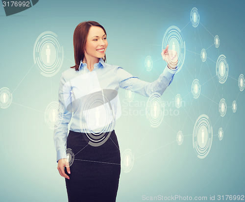 Image of smiling businesswoman working with virtual screen