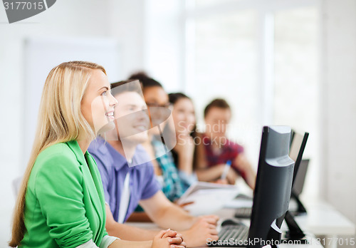 Image of students with computers studying at school