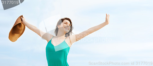 Image of girl in hat standing on the beach