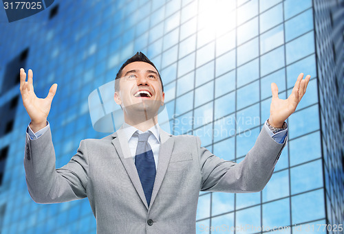 Image of happy laughing businessman in suit