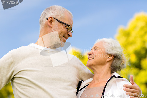 Image of senior couple hugging in city park