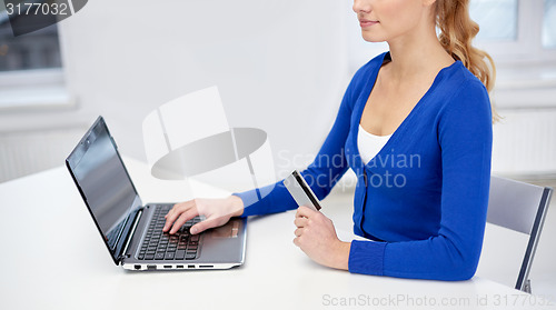 Image of close up of woman with laptop and credit card