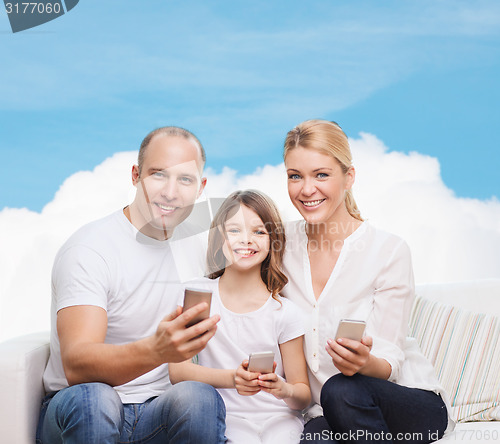 Image of happy family with smartphones