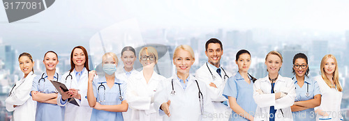 Image of smiling female doctors and nurses with stethoscope