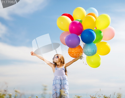 Image of happy girl with colorful balloons