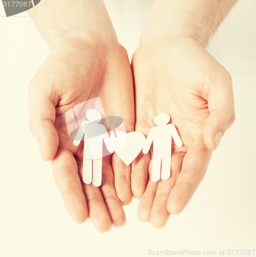 Image of man hands with paper men