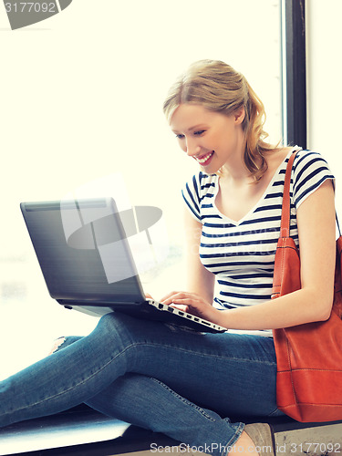 Image of happy teenage girl with laptop computer