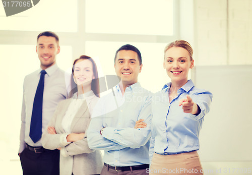 Image of businesswoman in office pointing finger at you