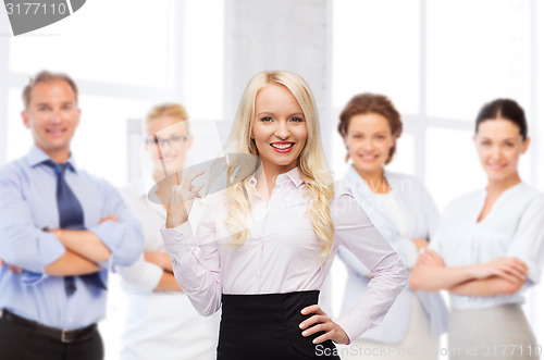 Image of smiling businesswoman or secretary in office