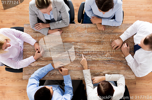 Image of close up of business team sitting at table