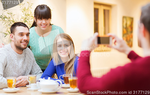 Image of group of friends taking picture with smartphone