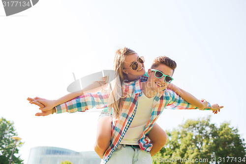 Image of smiling couple having fun in park