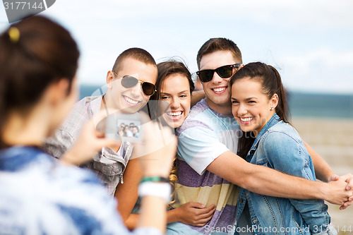 Image of teenagers taking photo outside