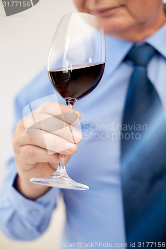 Image of close up of senior man drinking wine from glass