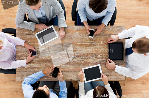Image of business team with smartphones and tablet pc