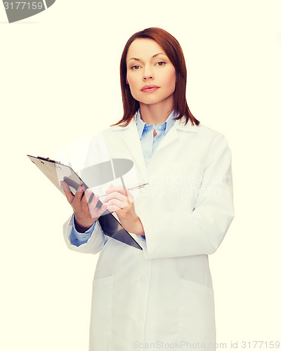 Image of smiling female doctor with clipboard