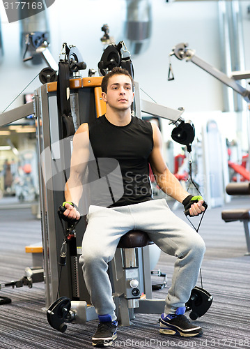 Image of man exercising on gym machine