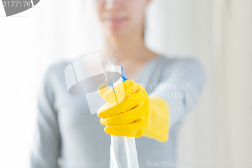 Image of close up of happy woman with cleanser spraying