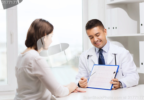 Image of smiling doctor and young woman meeting at hospital