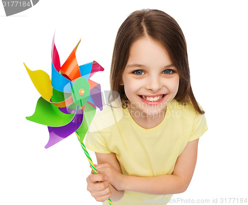 Image of smiling child with colorful windmill toy