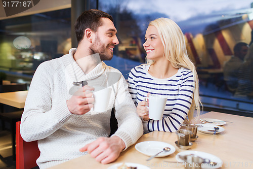 Image of happy couple meeting and drinking tea or coffee