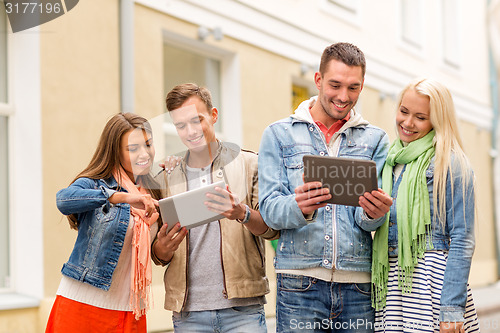 Image of group of smiling friends with tablet pc computers