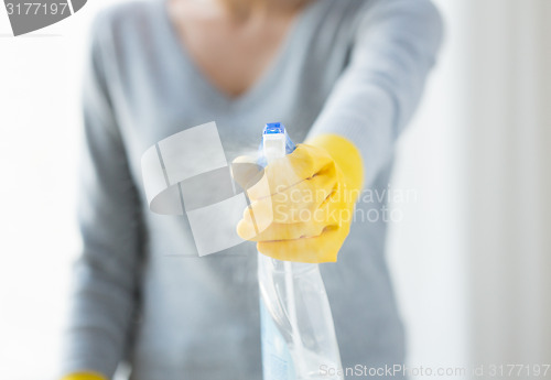 Image of close up of happy woman with cleanser spraying