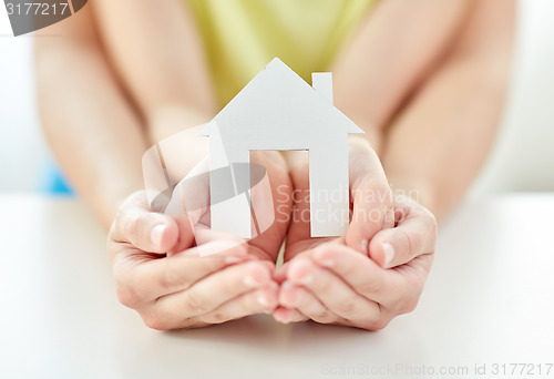 Image of close up of woman and girl hands with paper house