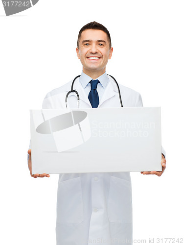 Image of smiling male doctor holding white blank board