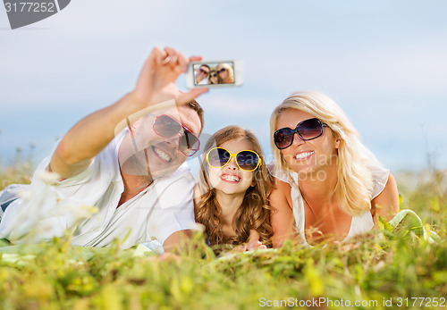 Image of happy family with camera taking picture