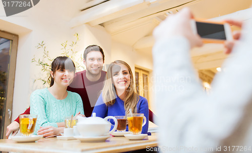 Image of group of friends taking picture with smartphone