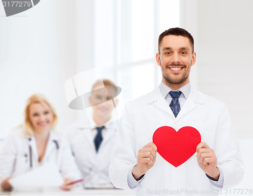 Image of smiling male doctor with red heart