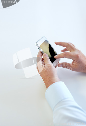 Image of close up of senior man hands with smartphone,