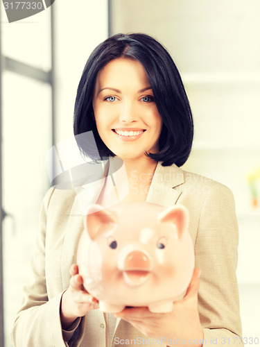 Image of lovely woman with piggy bank