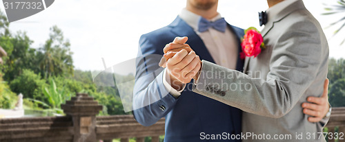 Image of close up of happy male gay couple dancing