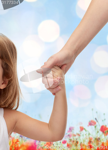Image of close up of woman and little girl holding hands