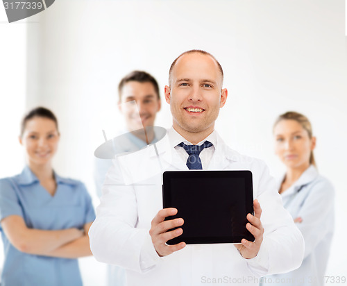 Image of smiling male doctor with tablet pc