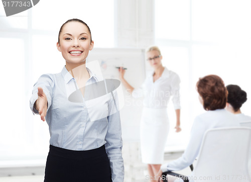 Image of businesswoman with opened hand ready for handshake