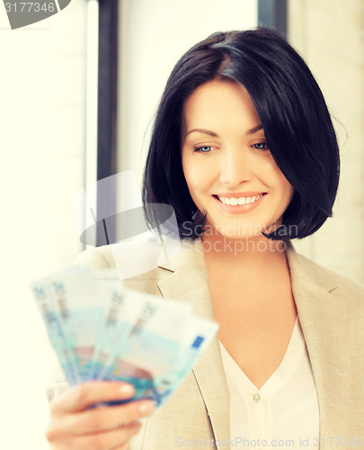 Image of lovely woman with euro cash money