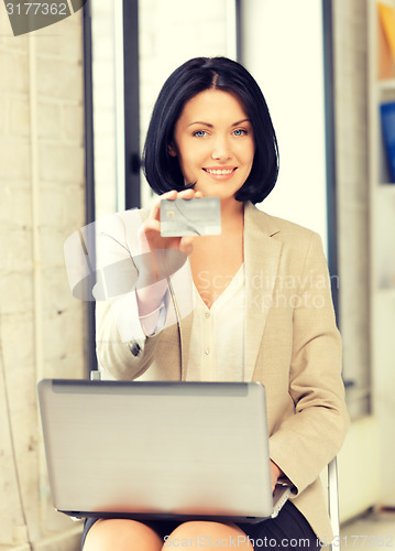 Image of happy woman with credit card