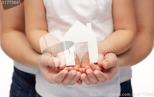 Image of close up of woman and girl hands with paper house