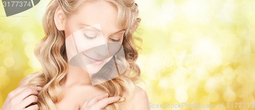 Image of beautiful young woman face with long wavy hair