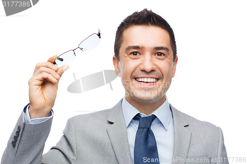 Image of happy smiling businessman in eyeglasses and suit